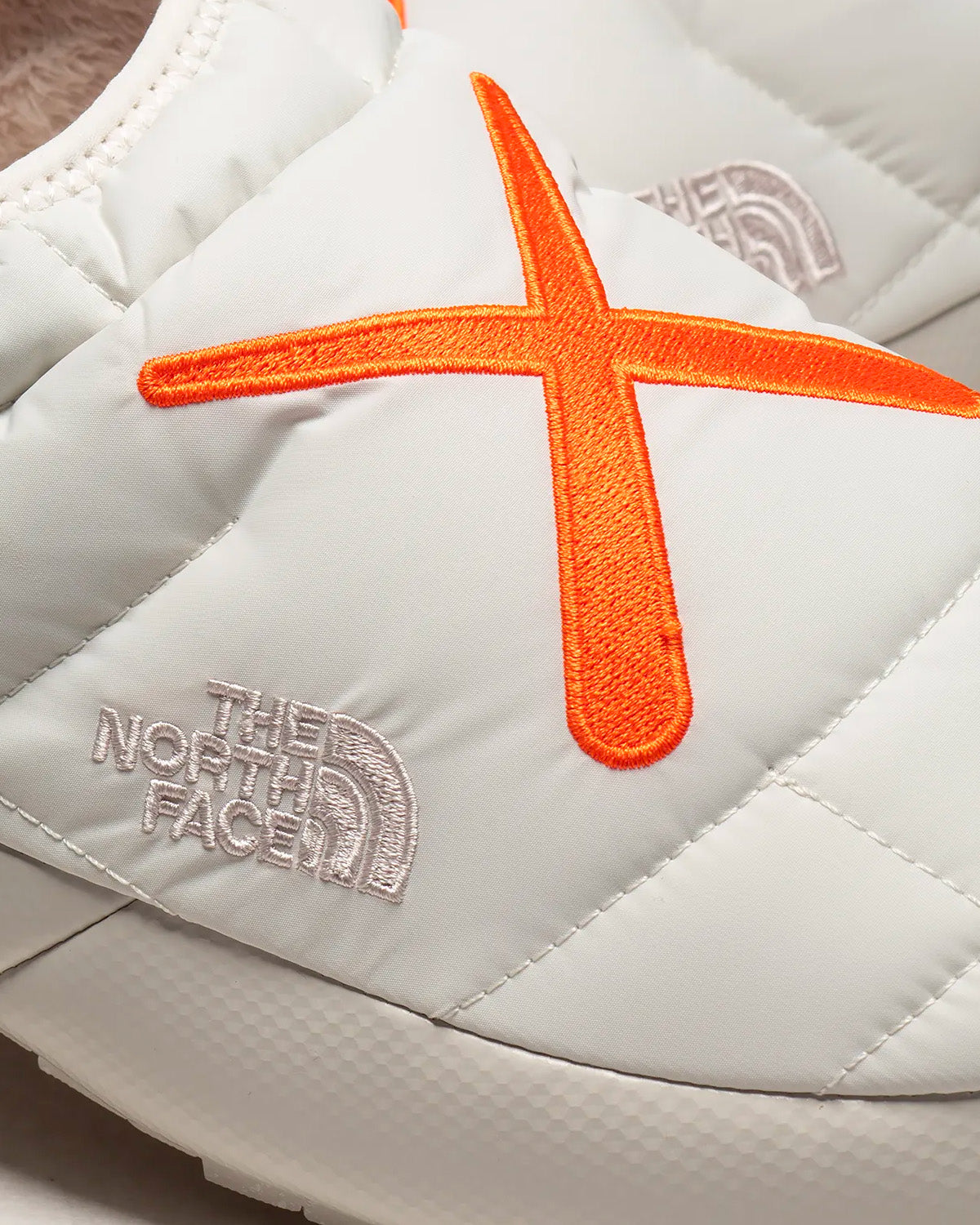 The North Face x KAWS - Thermoball Traction Mule V Moonlight Ivory / Persian Orange Slip Ons